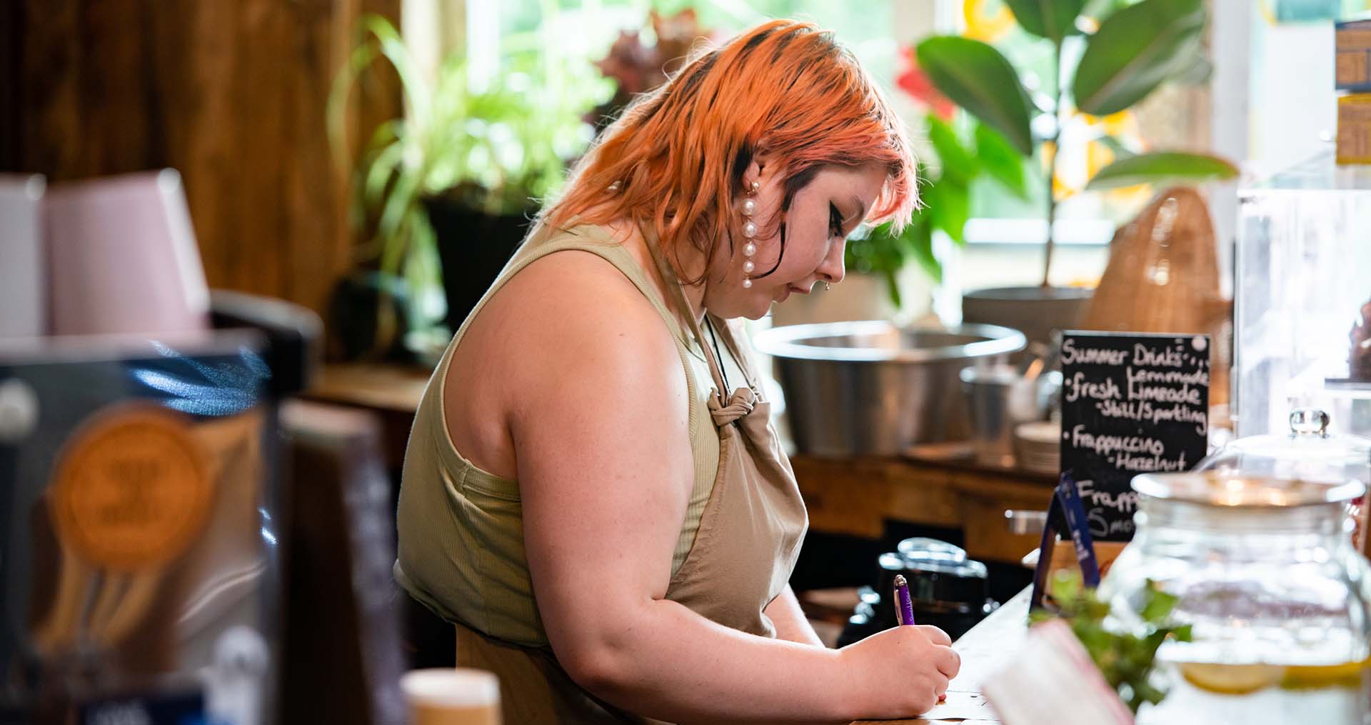 volunteer taking a customer order at cafe recharge in galashiels kat gollock