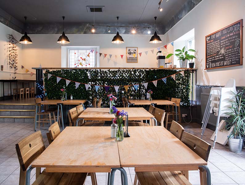 tables and chairs in the interior of cafe recharge in Galashiels