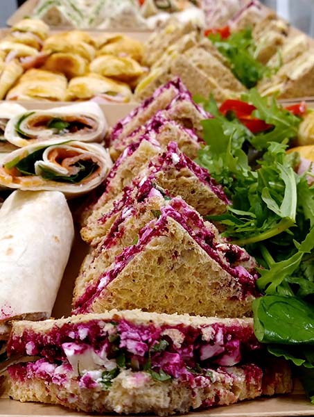 assorted wraps croissants and sandwiches garnished with salad boxed for catering at cafe recharge in galashiels
