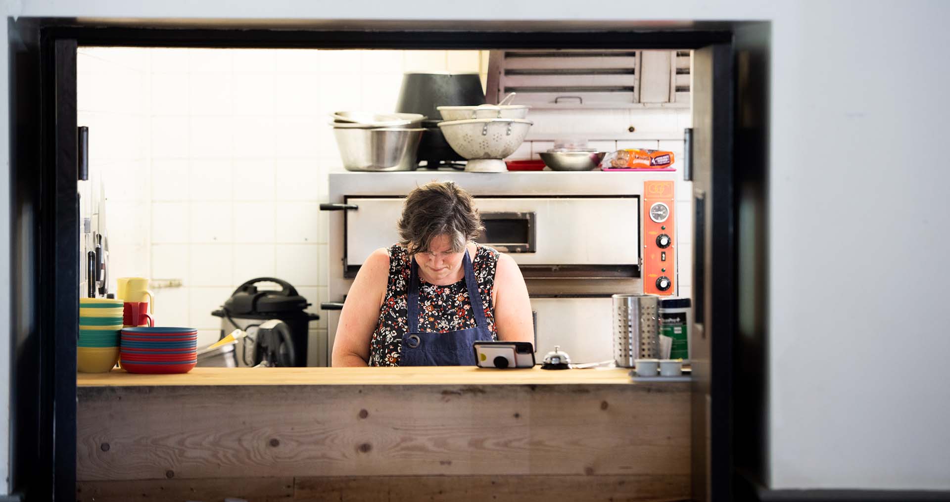 happy chef preparing lunch in the kitchen at cafe recharge in galashiels kat gollock